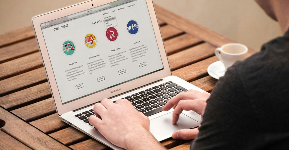 An image of a person working at a laptop.